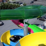View of the green tube of waterslide from top of waterslide