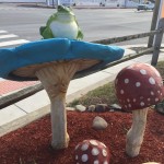 Decor of blue mushroom with frog sitting atop
