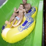 Father and son slide down waterpark waterslide