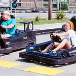 Older man and young woman ready to race go karts in Fenwick Island
