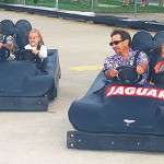 Two dads and daughters ride black go karts together