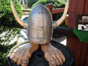 Troll feet wearing viking hat decor on mini golf course