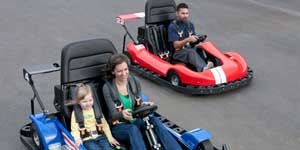 two go carts one with man one with woman and daughter