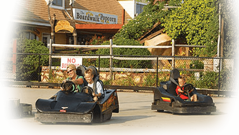 Young boy and mother driving go kart in Ocean City