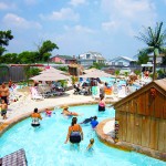 Women and kids swim in pool at local waterpark