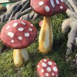 Three red and white mushroom decor at mini golf