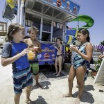 Kids enjoy icecream on the beach